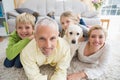 Happy parents with their children and puppy on floor Royalty Free Stock Photo