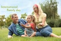 Happy parents and their daughter blowing soap bubbles in park on green grass. Happy Family Day Royalty Free Stock Photo