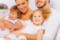 Happy parents with two adorable children on bed Royalty Free Stock Photo