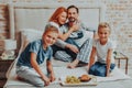 Happy parents and two kids having breakfast Royalty Free Stock Photo