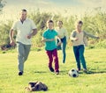 Happy parents with two kids playing soccer Royalty Free Stock Photo
