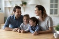 Happy parents using cellphone with small kids. Royalty Free Stock Photo