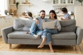 Happy parents using laptop while kids playing funny game Royalty Free Stock Photo