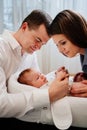 Happy parents with young son in a lounger for newborns. loving family