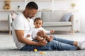 Happy Paternity Leave. Young Black Father Bonding With Infant Baby At Home Royalty Free Stock Photo