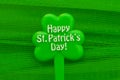 Happy Patrick`s day inscription on green maple leaf on green background Royalty Free Stock Photo