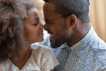 Happy peaceful african american family enjoying tender lovely moment.