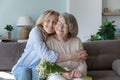 Happy peaceful caring senior daughter woman embracing elderly mom Royalty Free Stock Photo