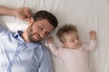 Happy peaceful dad and cute baby daughter sleeping in bed Royalty Free Stock Photo