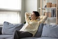 Happy peaceful middle aged retired woman relaxing on cozy sofa. Royalty Free Stock Photo