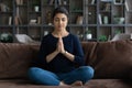 Happy peaceful young Indian woman praying God.