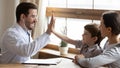 Happy pediatrician greeting with small boy patient Royalty Free Stock Photo