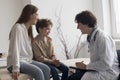 Happy pediatrician man talking to patient, asking about health