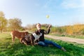 Happy pensioner with English bulldog playing on the grass in park. Dog training. Free time in retirement Royalty Free Stock Photo