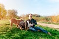 Happy pensioner with English bulldog playing on the grass in park. Dog training. Free time in retirement Royalty Free Stock Photo