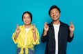 Happy pensive asian couple in casual with crossed fingers dream, make wish come true Royalty Free Stock Photo