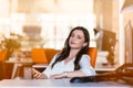 Happy pensive businesswoman planning and looking sideways at office Royalty Free Stock Photo