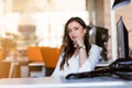 Happy pensive businesswoman planning and looking sideways at office Royalty Free Stock Photo