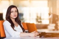 Happy pensive businesswoman planning and looking sideways at office Royalty Free Stock Photo