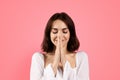 Happy pensive millennial caucasian brunette woman praying with hands