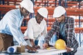 Happy people, architect and meeting on blueprint for construction, planning or collaboration on site. Group in teamwork Royalty Free Stock Photo
