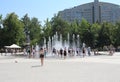 happy people and children bathe in the city fountain in the summer in the park water from the heat Royalty Free Stock Photo