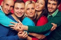 Happy people concept. Portrait of five stylish close friends hugging, smiling and posing together