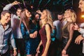 Happy people are dancing in club. Nightlife and disco concept Royalty Free Stock Photo