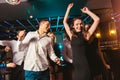 Happy people are dancing in club. Nightlife and disco concept Royalty Free Stock Photo