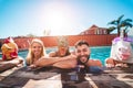 Happy people doing pool private party while wearing funny animals masks - Young friends having fun in summertime - Alternative Royalty Free Stock Photo