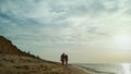 Happy people going beach by sea waves. Family enjoy weekend on shore nature view