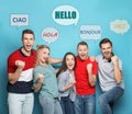 Happy people and illustration of speech bubbles with word Hello written in different languages on light blue background Royalty Free Stock Photo