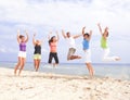 Happy people jumping on the beach Royalty Free Stock Photo