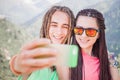 Happy people make selfie on mobile phone at mountain outdoor Royalty Free Stock Photo