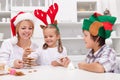 Happy people making gingerbread christmas tree Royalty Free Stock Photo