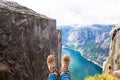 Happy people relax in cliff during trip Norway. hiking route
