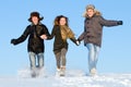 Happy people running in winter Royalty Free Stock Photo