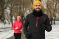 Happy people running in winter park. Outdoors sports exercises Royalty Free Stock Photo