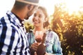 People tasting wine in vineyard