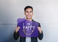 Happy Person Concept. Young Man Smiling and Show I am Happy Text on Speech Bubble Card. Positive Human Face Expression. Good