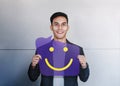 Happy Person Concept. Young Man Smiling and Show Smile Icon on Speech Bubble Card. Positive Human Face Expression