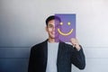 Happy Person Concept. Young Man Smiling and Show Smile Icon on Transparent Card. Positive Human Face Expression