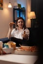 Happy person after work looking at television sitcom show eating a slice of hot pizza delivery Royalty Free Stock Photo