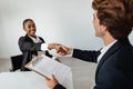 Happy personnel manager and black female job applicant shaking hands after successful employment interview in office Royalty Free Stock Photo