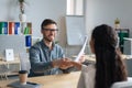 Happy personnel manager and female job applicant shaking hands after successful employment interview at modern office Royalty Free Stock Photo