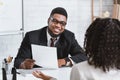 Happy personnel manager and young job applicant on work interview at company office Royalty Free Stock Photo