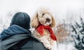 Happy pet and his owner having fun in the snow in winter holiday season. Winter holiday emotion. Royalty Free Stock Photo