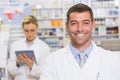 Happy pharmacist looking at camera