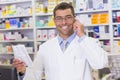 Happy pharmacist on the phone looking at the camera