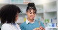 Happy pharmacy woman consultant helping customer with her prescription. Female pharmacist giving instructions to her Royalty Free Stock Photo